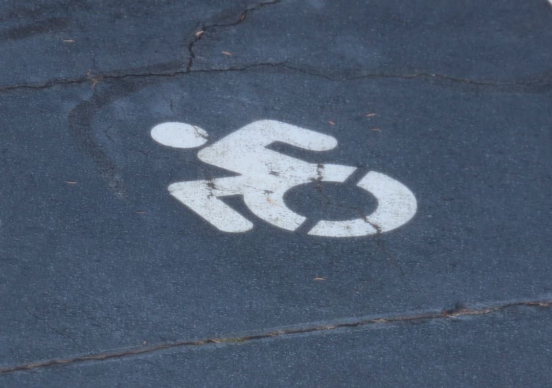 workplace rights. A handicap sign painted on the pavement of a street