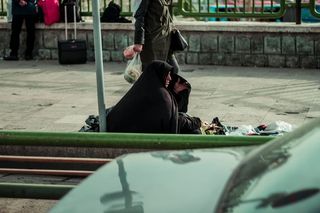 service dog school. Woman in black hijab sitting on the ground.
