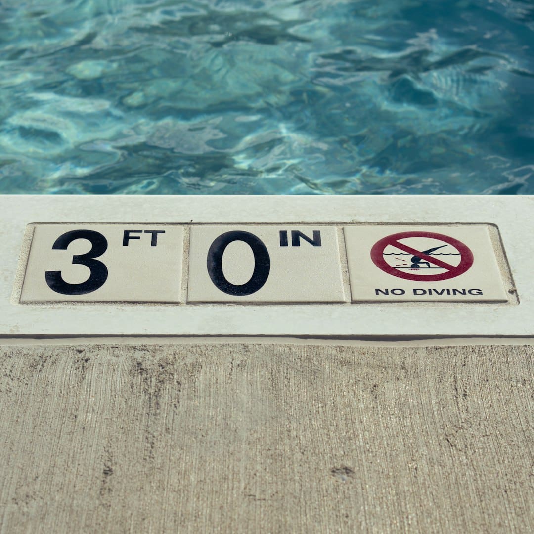 ADA complaint — Swimming pool edge with depth marker and no diving sign